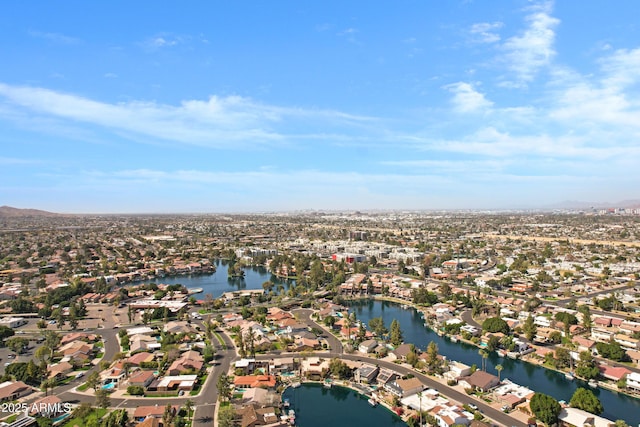 birds eye view of property with a water view and a residential view