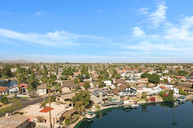 drone / aerial view with a residential view and a water view