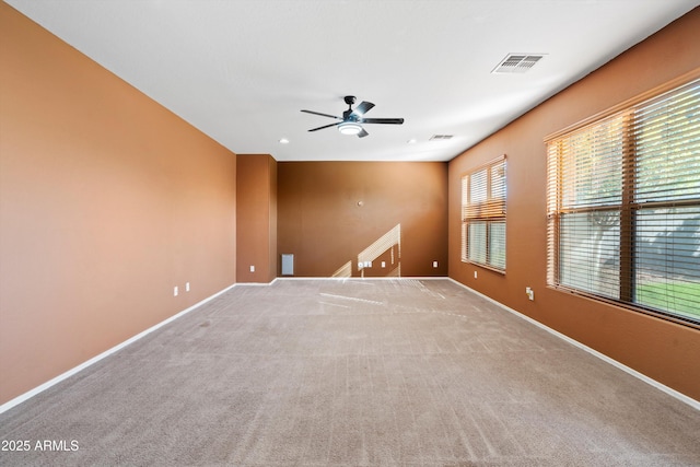 spare room featuring ceiling fan and light colored carpet