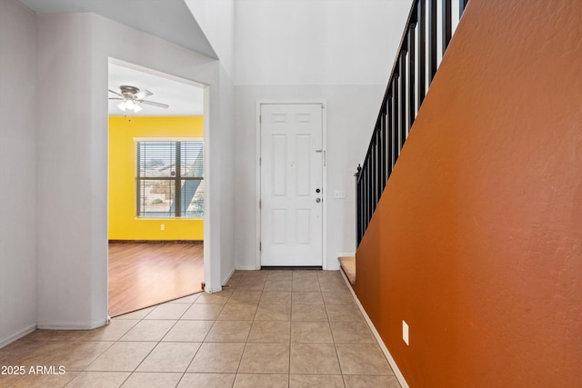 tiled entryway featuring ceiling fan