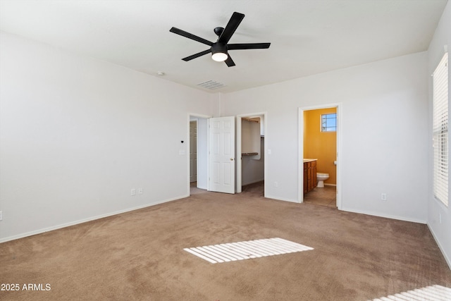 unfurnished bedroom featuring ceiling fan, connected bathroom, and light carpet