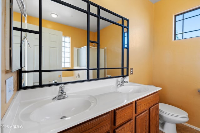 bathroom featuring toilet and vanity