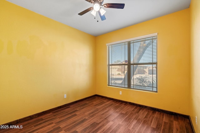 empty room featuring ceiling fan and dark hardwood / wood-style flooring