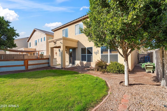 rear view of property with a lawn