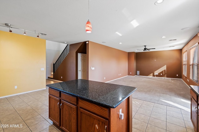 kitchen featuring rail lighting, hanging light fixtures, a center island, and light tile patterned flooring