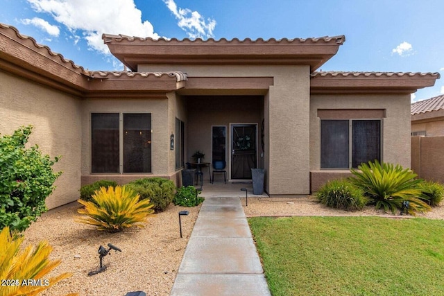 2685 N 132nd Dr, Goodyear, AZ 85395 - property entrance with stucco siding, a lawn, and a tiled roof