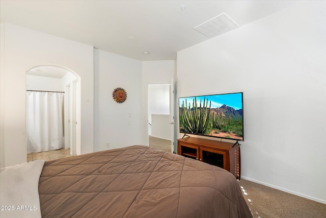 bedroom featuring light carpet