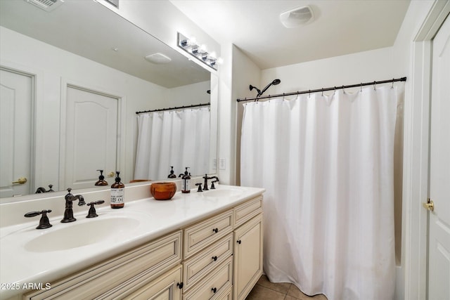 bathroom featuring walk in shower, tile patterned flooring, and vanity