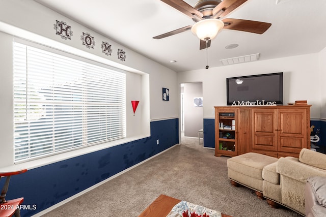 interior space with carpet floors and ceiling fan