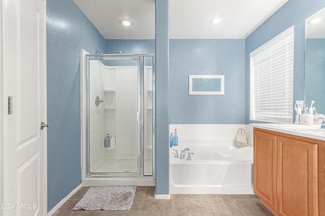 bathroom with vanity, independent shower and bath, and tile patterned floors