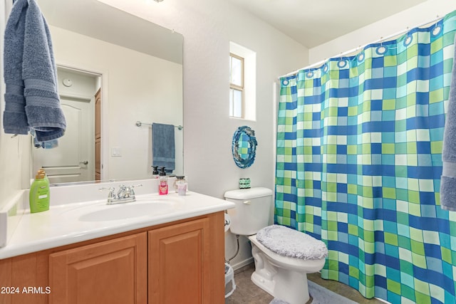 bathroom featuring vanity, tile patterned floors, and toilet