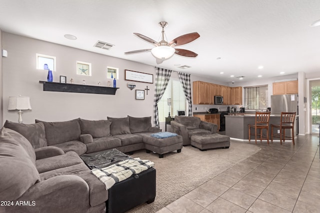 tiled living room featuring ceiling fan