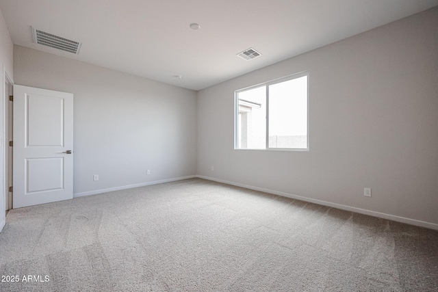 carpeted empty room with baseboards and visible vents