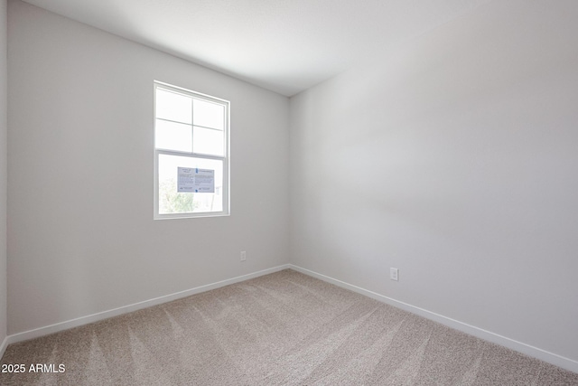 carpeted empty room with baseboards