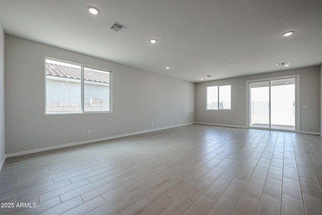 spare room featuring recessed lighting, baseboards, and visible vents