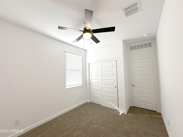 unfurnished bedroom featuring carpet floors, baseboards, visible vents, and a closet