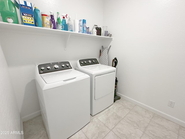 laundry room with marble finish floor, laundry area, separate washer and dryer, and baseboards