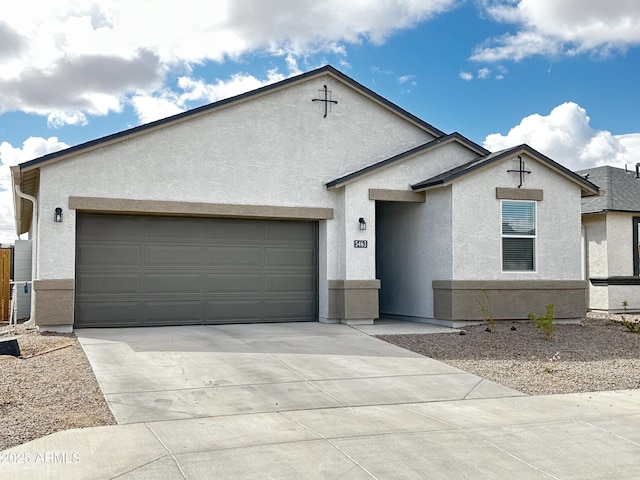 view of front facade featuring driveway, an attached garage, and stucco siding