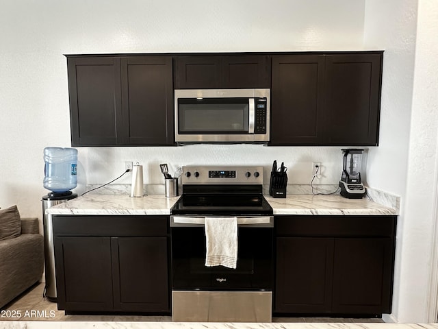 kitchen with stainless steel appliances and light stone countertops