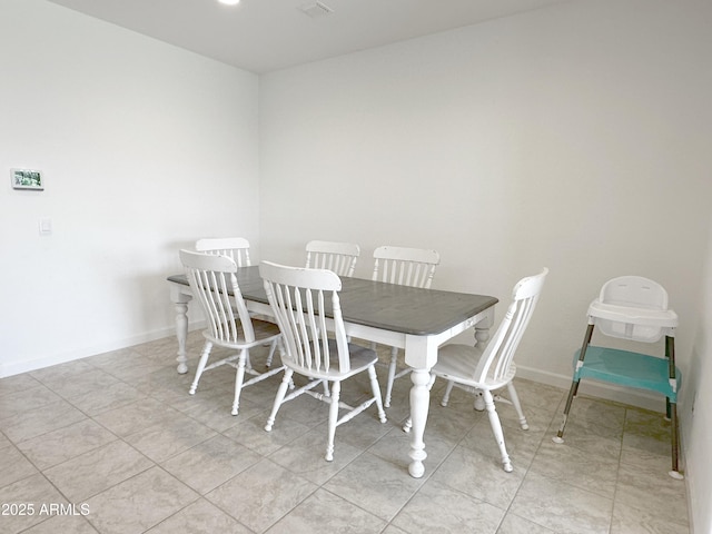 dining area featuring baseboards and light tile patterned floors