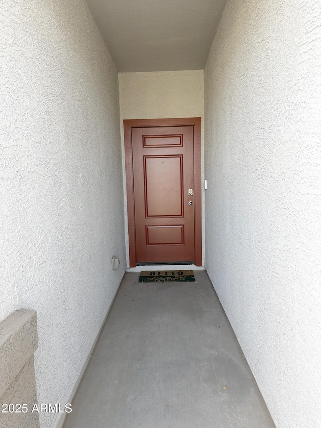 property entrance with stucco siding