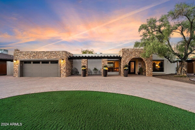 view of front of home featuring a garage and a lawn