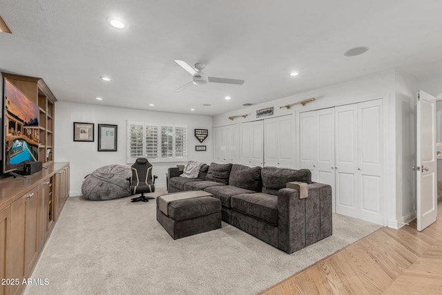living area with a ceiling fan, baseboards, light wood-style floors, and recessed lighting