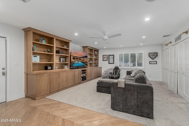 living room with baseboards, visible vents, recessed lighting, and a ceiling fan