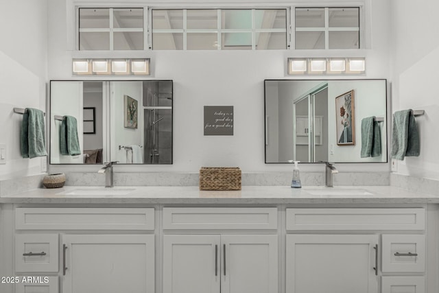 full bath featuring double vanity, a sink, and walk in shower