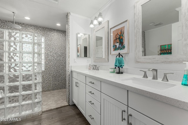 full bathroom with crown molding, a sink, walk in shower, and wood finished floors