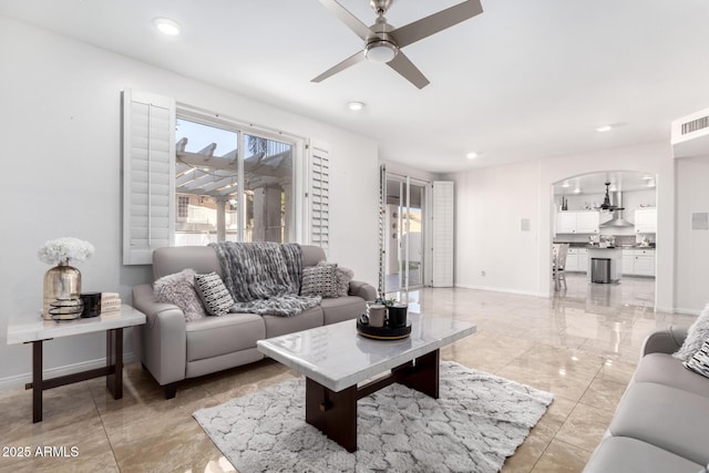 living room with a healthy amount of sunlight and ceiling fan