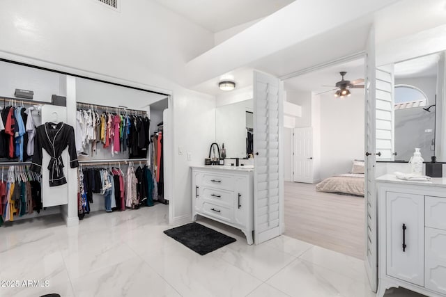 bathroom with ceiling fan and vanity