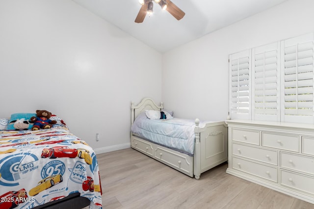 bedroom with ceiling fan, light hardwood / wood-style floors, and lofted ceiling