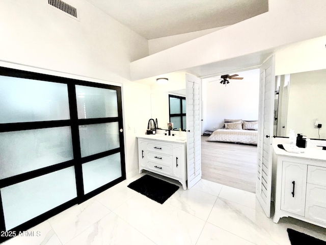5748 W Soft Wind Dr, Glendale, AZ 85310 - ensuite bathroom with visible vents, marble finish floor, connected bathroom, two vanities, and a ceiling fan