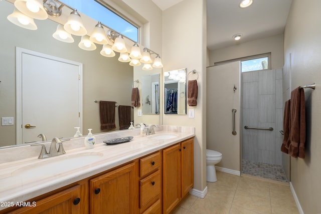 bathroom featuring vanity, toilet, a shower with shower door, and tile patterned flooring