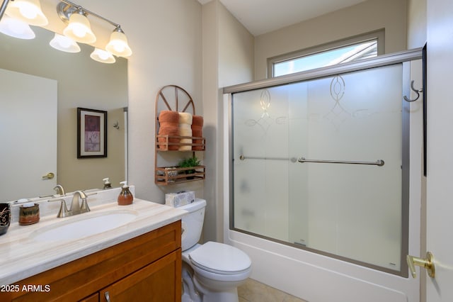 full bathroom featuring enclosed tub / shower combo, vanity, and toilet