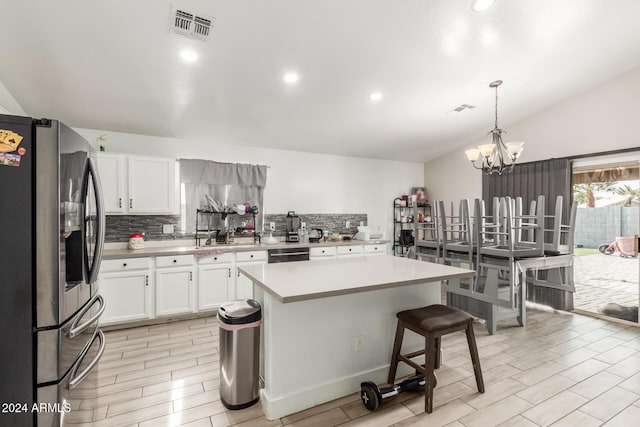 kitchen featuring white cabinets, stainless steel fridge with ice dispenser, a center island, and hanging light fixtures