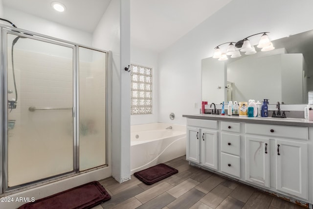 bathroom featuring vanity and separate shower and tub