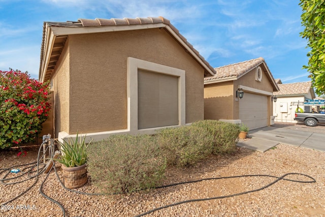 view of side of home featuring a garage