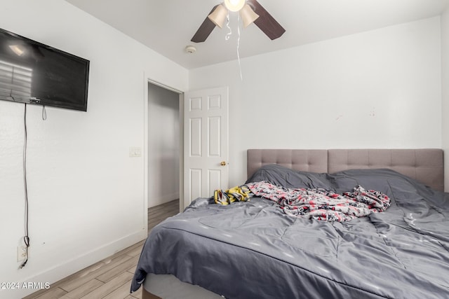 bedroom with light wood-type flooring and ceiling fan