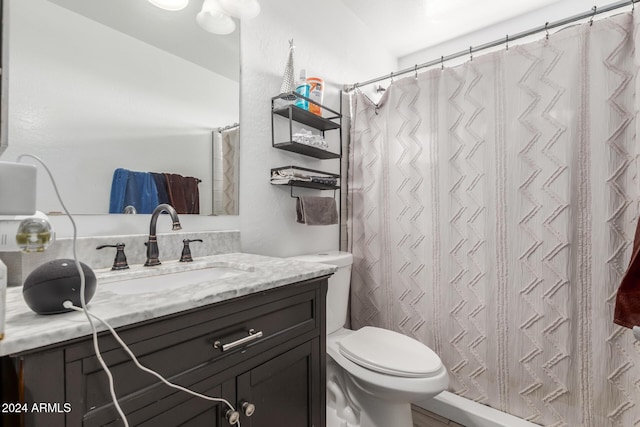 bathroom featuring a shower with curtain, vanity, and toilet