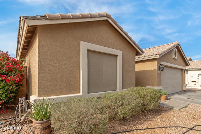 view of side of home featuring a garage