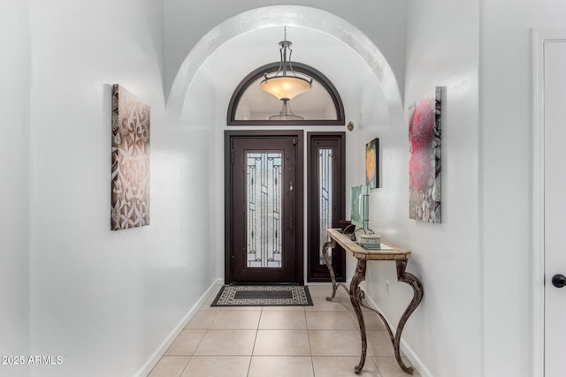 entryway with baseboards and light tile patterned flooring