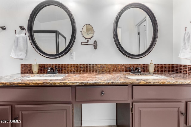 full bathroom featuring double vanity, tasteful backsplash, and a sink