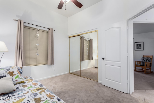 carpeted bedroom featuring ceiling fan, baseboards, and a closet