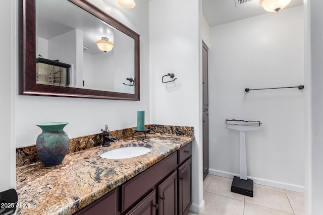 bathroom with tile patterned flooring, visible vents, vanity, and baseboards