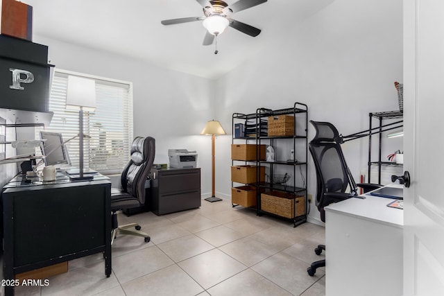 home office with lofted ceiling, light tile patterned floors, baseboards, and a ceiling fan