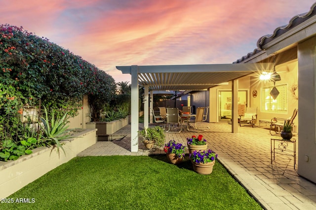 view of yard featuring a patio, outdoor dining area, a fenced backyard, and a pergola