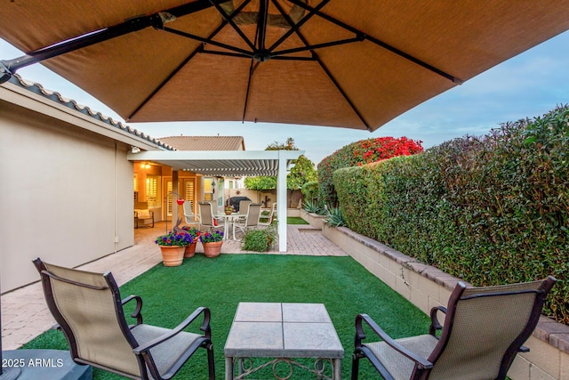 view of patio with outdoor dining space, a fenced backyard, and a pergola