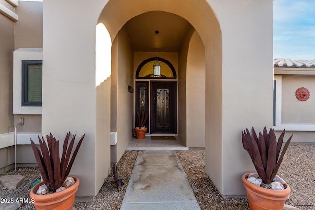 property entrance with stucco siding